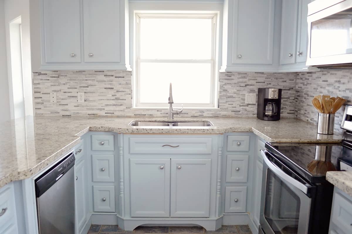 Renovated kitchen with granite counters and a dishwasher