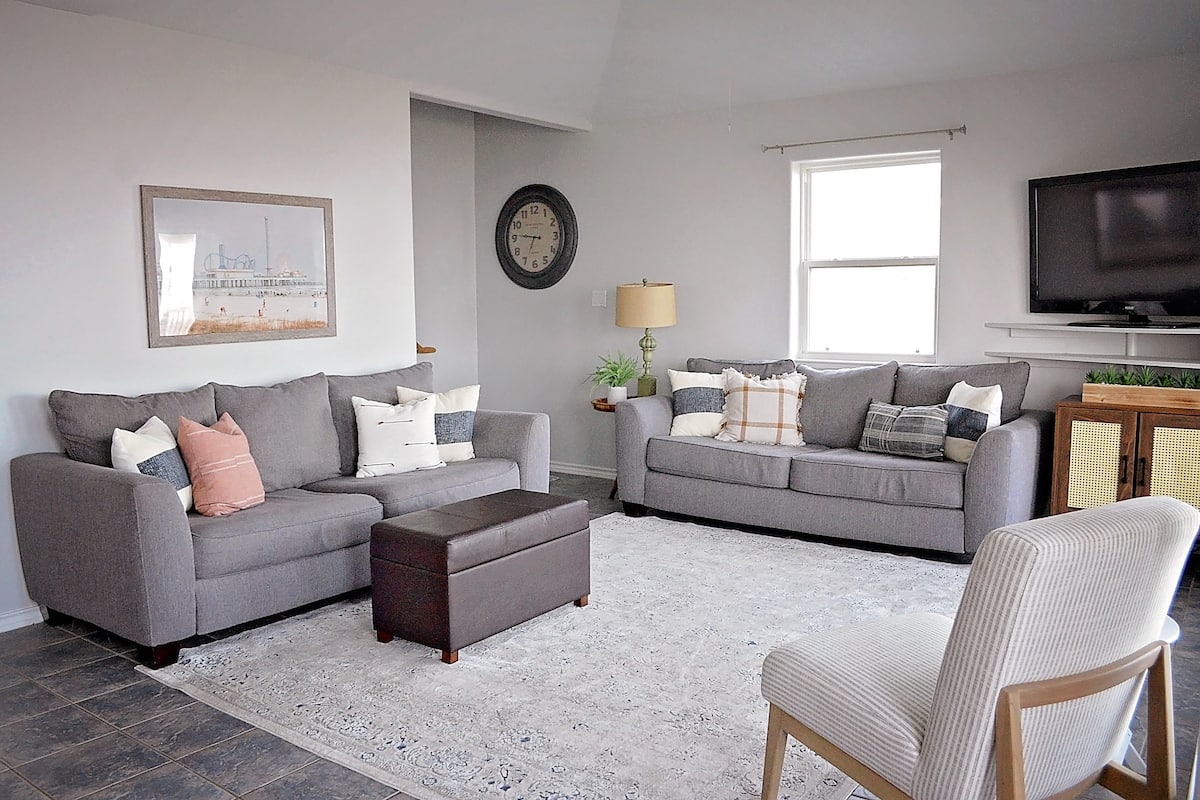 Living room with two gray sofas and a TV