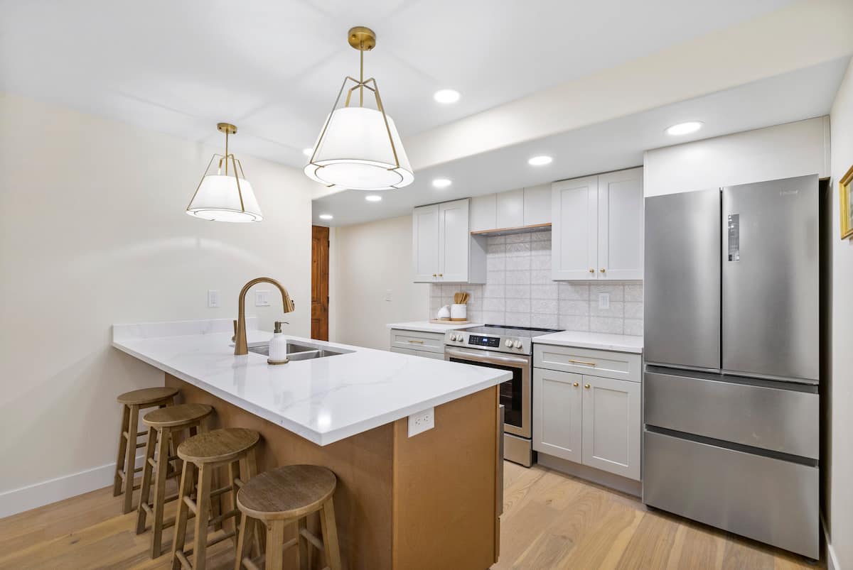 Kitchen with stainless steel appliances and an island with seating